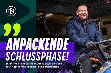 Image description: The image shows a person sitting on a small vehicle or piece of equipment, presumably a ride-on lawnmower or similar. The person is wearing a thick, blue winter jacket and gloves. On the left of the picture is a graphic area with the logo of the German Football Association (DFB) and large text: "ANPACKENDE SCHLUSSPHASE! Volunteering is priceless. Thank you to everyone who lends a hand even after the final whistle. dfb.de/ehrenamt".