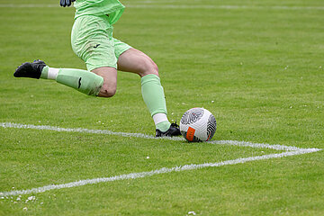 Person in hellgrüner Torwartkleidung spielt einen Fußball nahe der Seitenlinie; sichtbar sind Beine, Ball und grüner Rasen. Foto: Sandra Ritschel