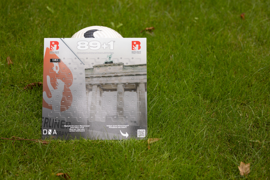 A billboard featuring the Brandenburg Gate and the BFV logo stands on the grass in front of a soccer ball. Photo: BFV